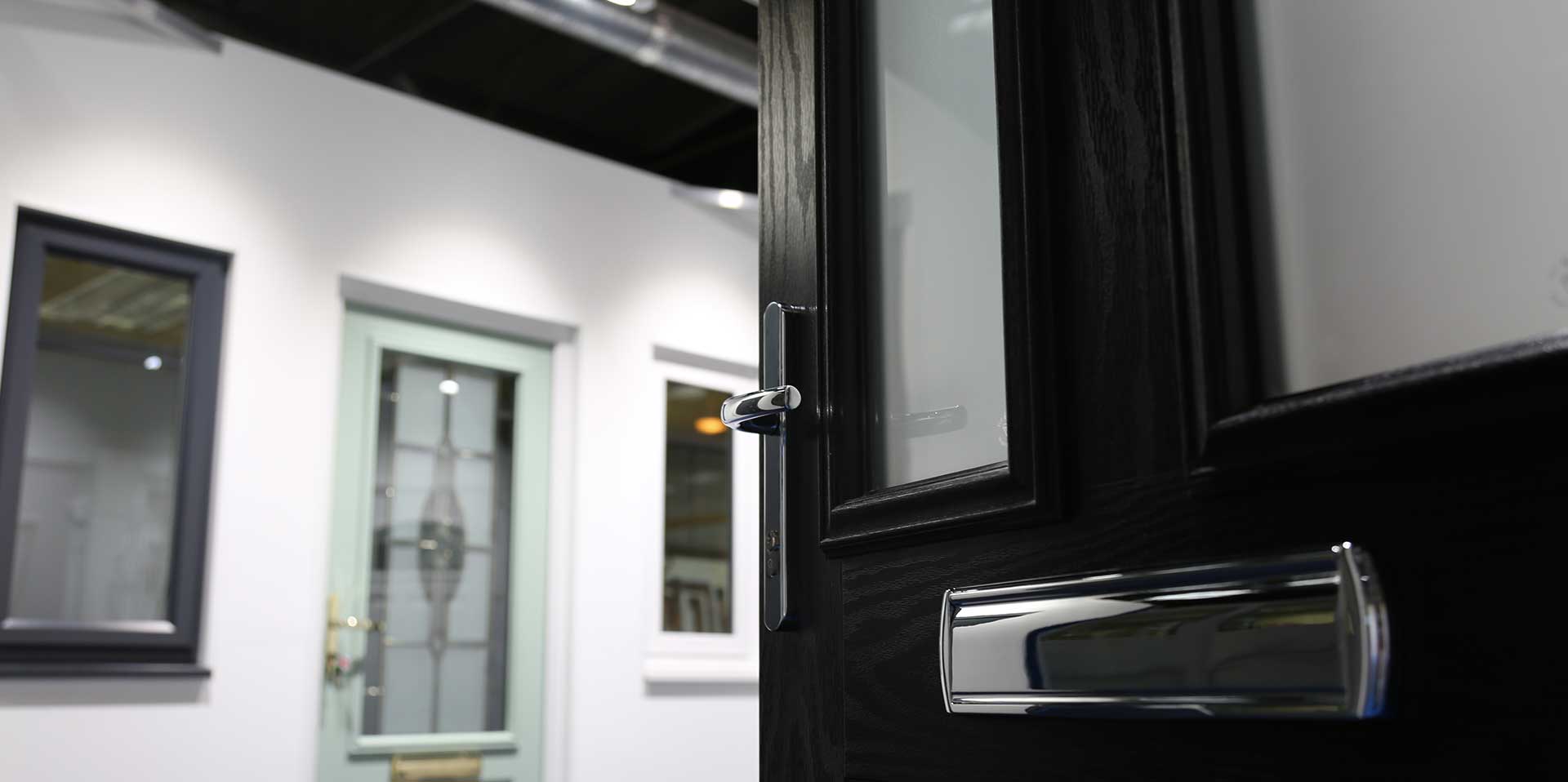 Black composite door in our product showroom