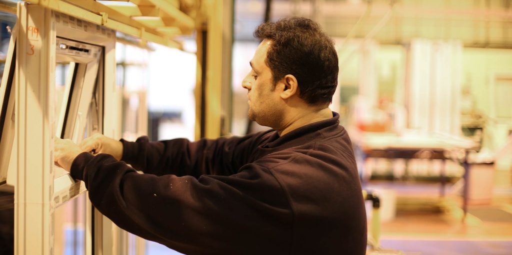 One of the Shelforce factory workers checking one of our window frames