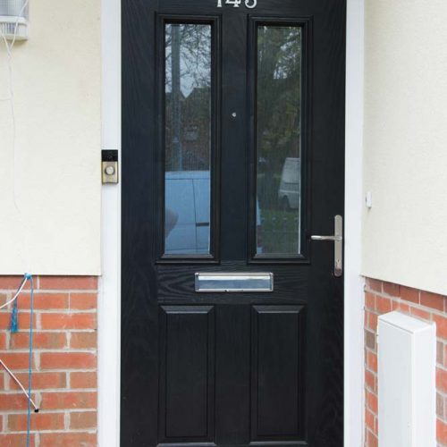 Black composite door with chrome hardware