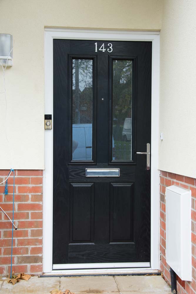 Black composite door with chrome hardware