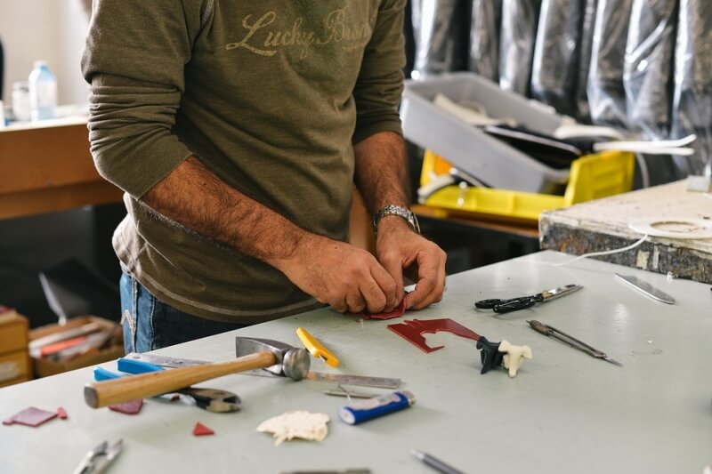 Worker on a table with tools and materials