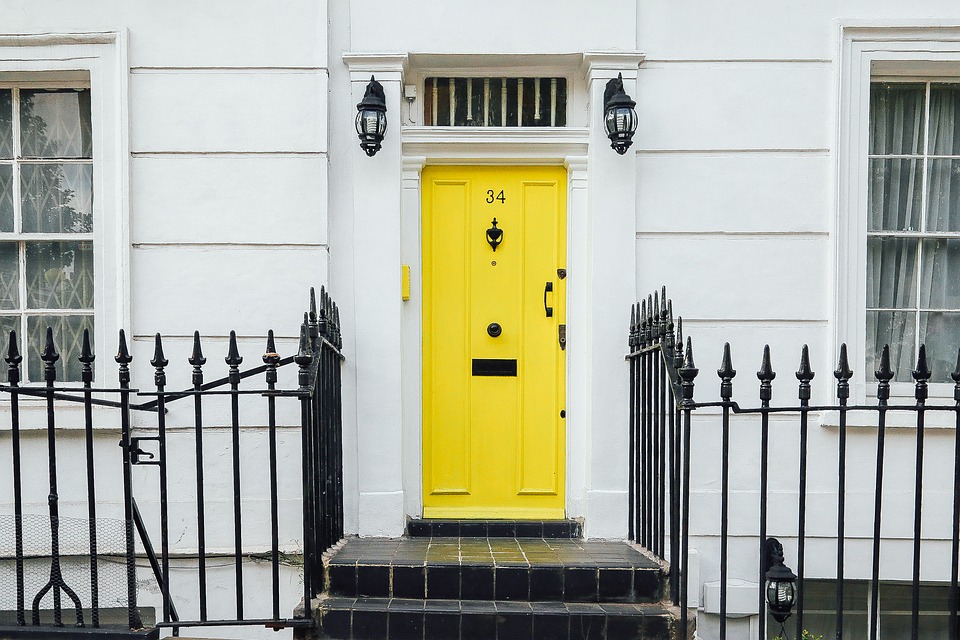 Bespoke yellow door on white house