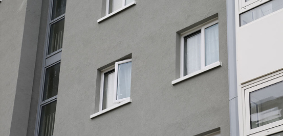 Exterior shot of grey building with white uPVC windows