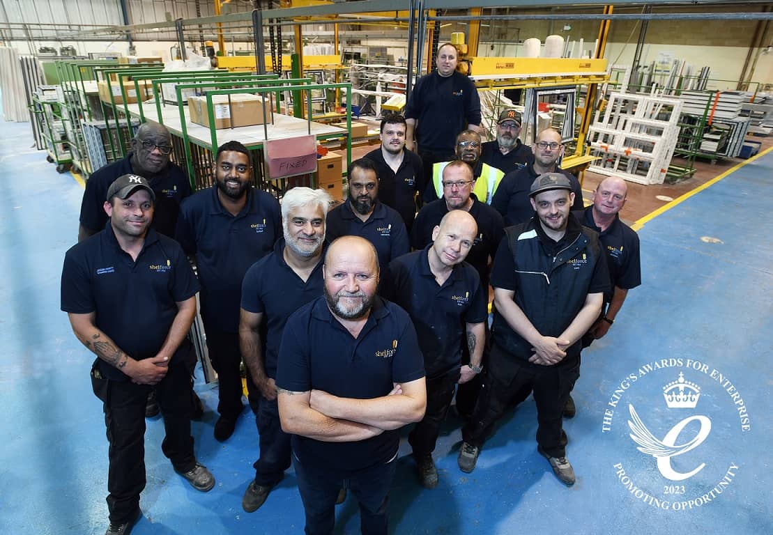 Team photo at the shelforce factory featuring the King's Award for Enterprise Winners Logo