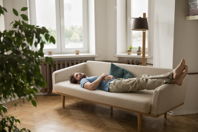 Man relaxing on his sofa in a comfortable lounge